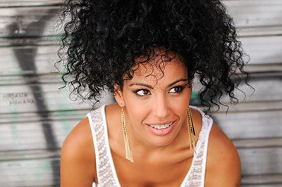Young Black Woman with braces smiling